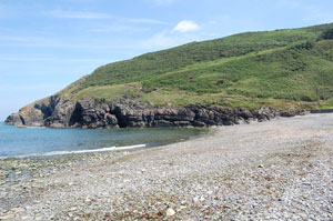 Cwm Tydu Beach with path on headland to New Quay